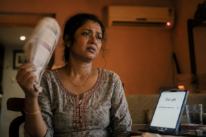 AC service near me - woman searching for AC repair in Kolkata on her phone