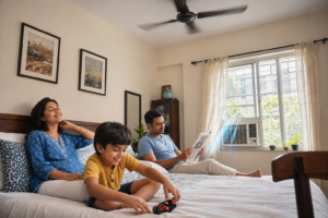 window AC in Kolkata - happy Bengali family relaxing in a cool apartment bedroom with window AC installed in Kolkata home by One Point Solution